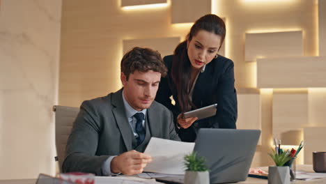 worried managers analyzing office papers closeup. serious colleagues talking