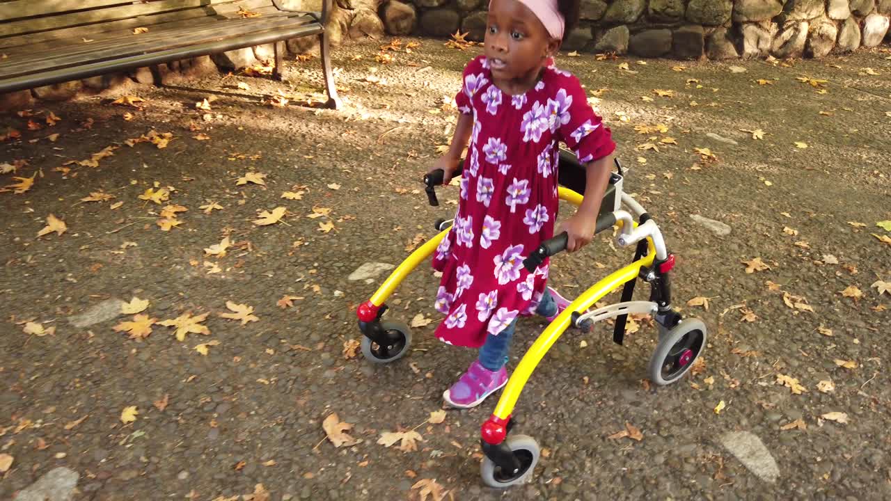Black girl with Cerebral Palsy walking in the park with her assistive device-2