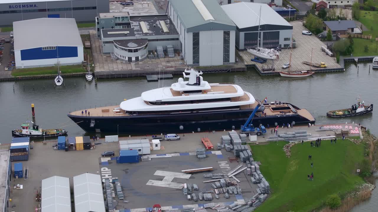 Area marittima con yacht, rimorchiatore e capannoni a Makkum, Paesi Bassi
