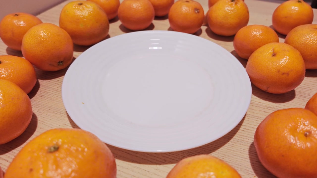 Symmetrical citrus display frames a blank plate ready for healthy meals