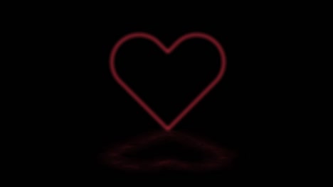 forma di cuore luminosa rossa con una luce discoteca su uno sfondo nero