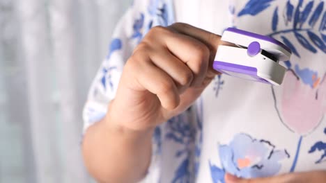 person using a pulse oximeter