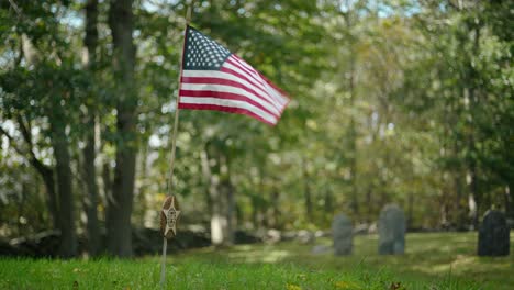 honor the past with this patrioticvideo featuring an american flag gently waving in an old cemetery from the 1800s