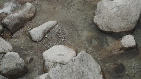 camera tilts over a mountain stream in the italian alps 4k slow motion