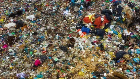 drone view moving above garbage dump with tone of plastic