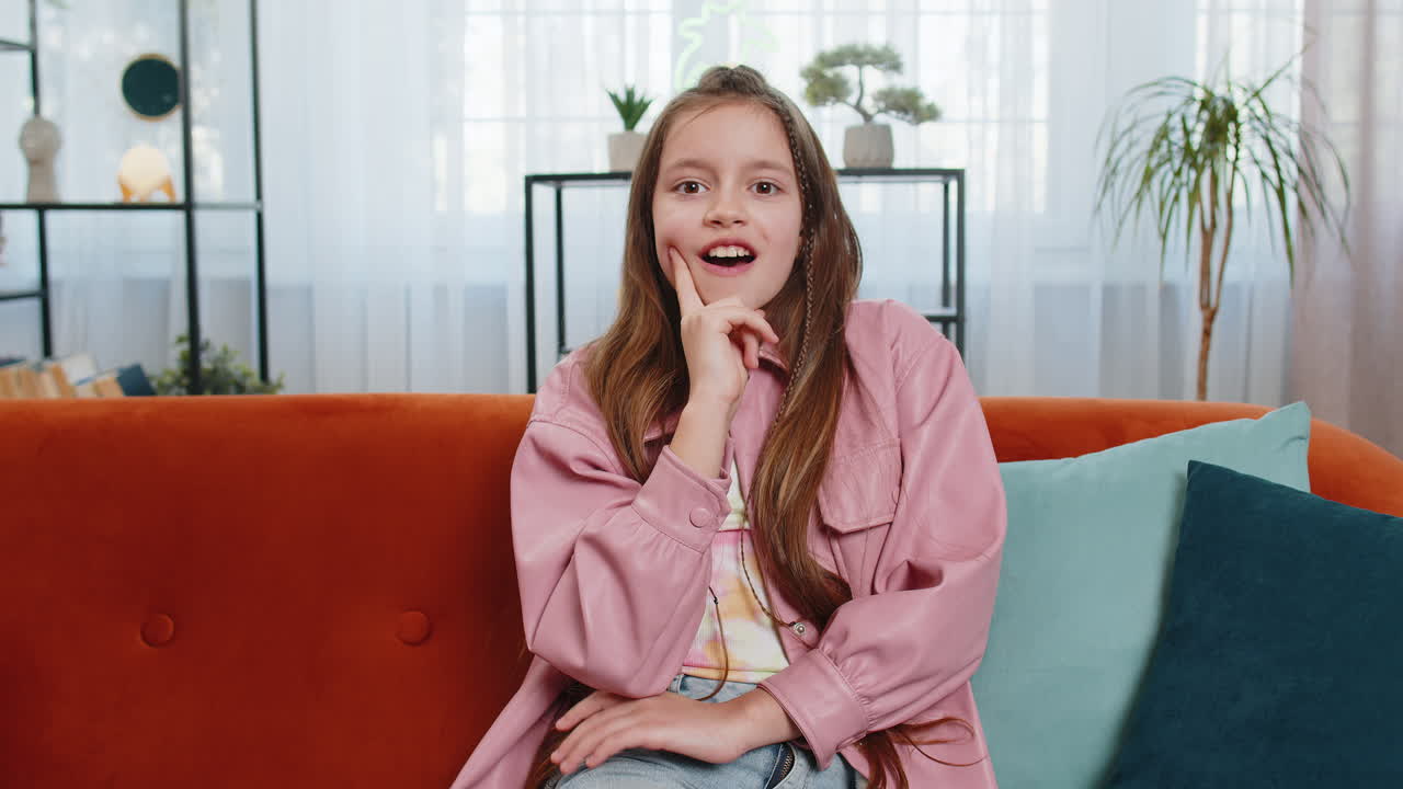 Inspired child girl pointing finger up having good idea plan showing inspiration motivation gesture