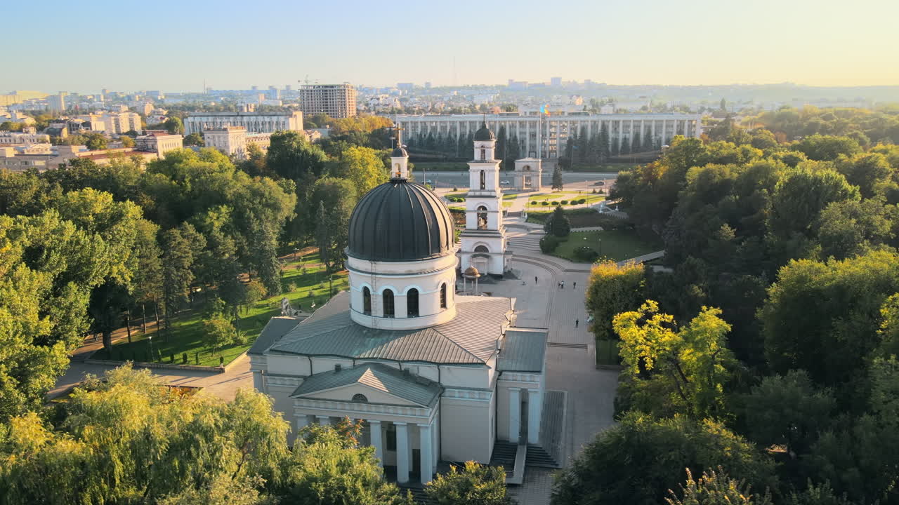 Aerial drone view of Chisinau downtown. Panorama view of central park, Cathedral, bell tower, a lot of greenery, walking people, buildings. Moldova
