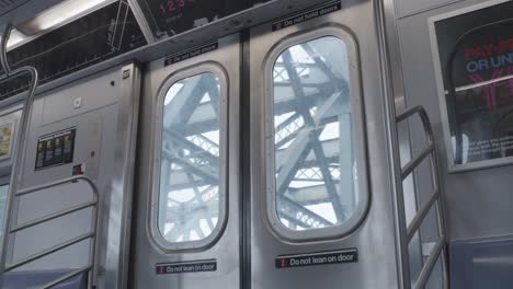 new york subway train cart passing over bridge