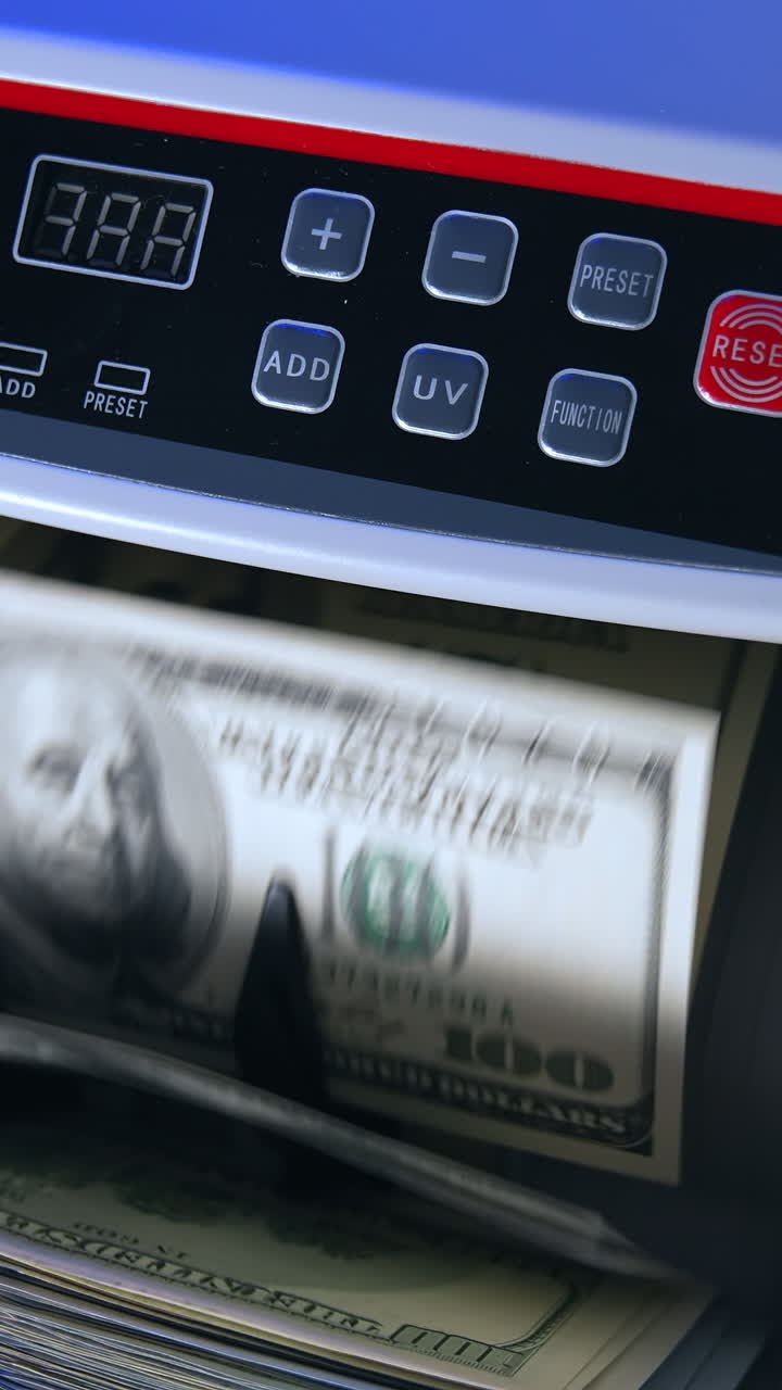 Dollar counting equipment in bank. Money banking counter. Money and economics concept. Cropped view. Vertical video