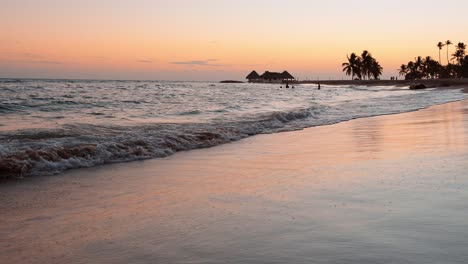 Sandy-Shoreline-Hit-By-Ocean-Waves-At-Dusk-In-Summer