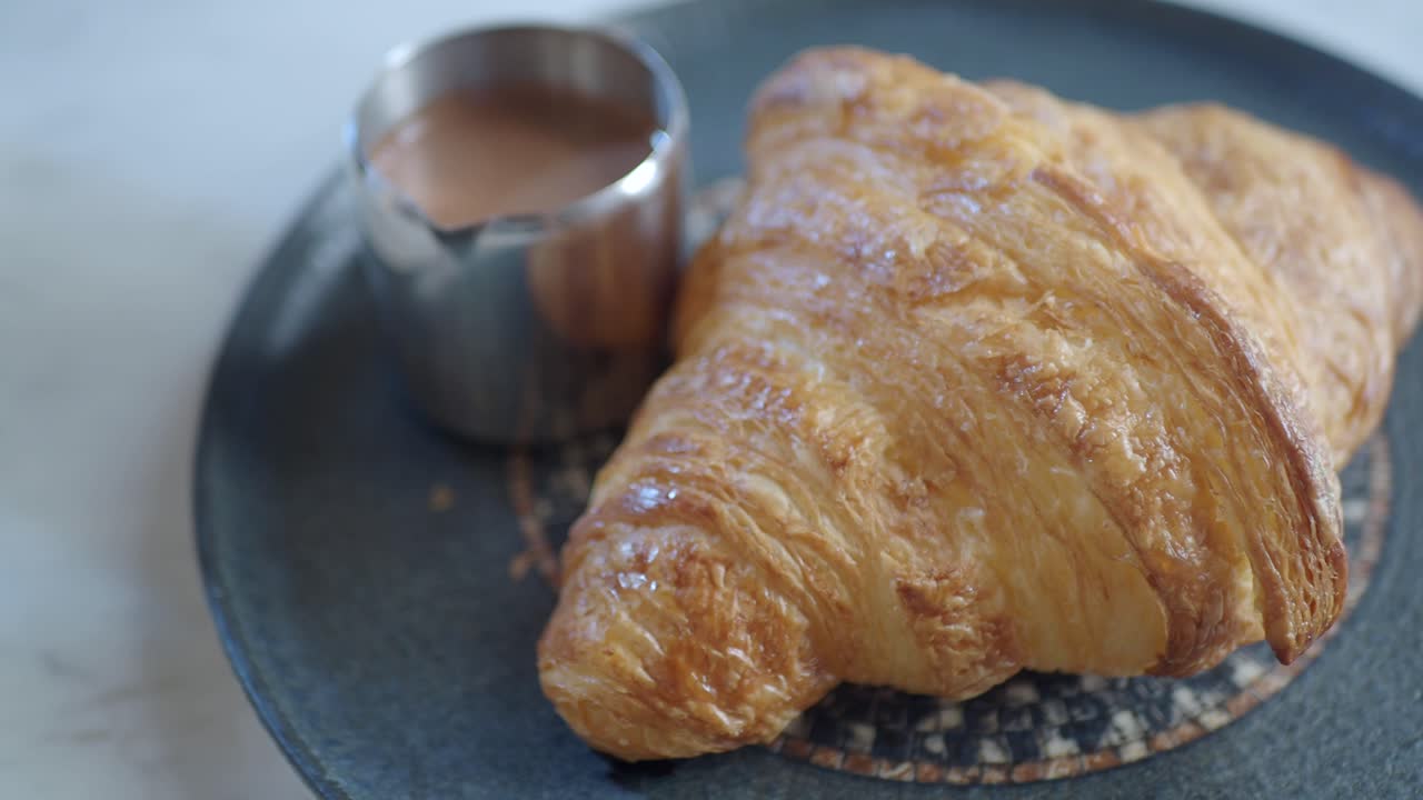 primer plano de un delicioso croissant con salsa de chocolate
