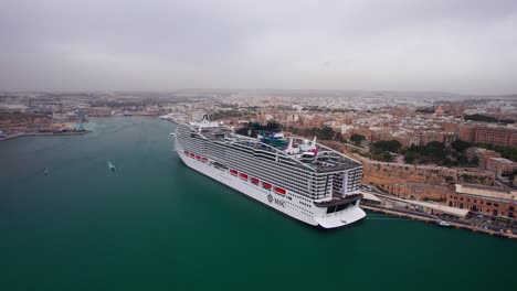 huge cruise ship docked in grand harbour of valletta, malta