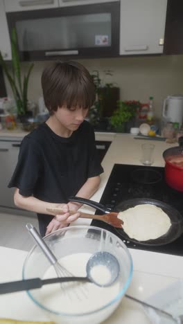 boy cooking pancakes