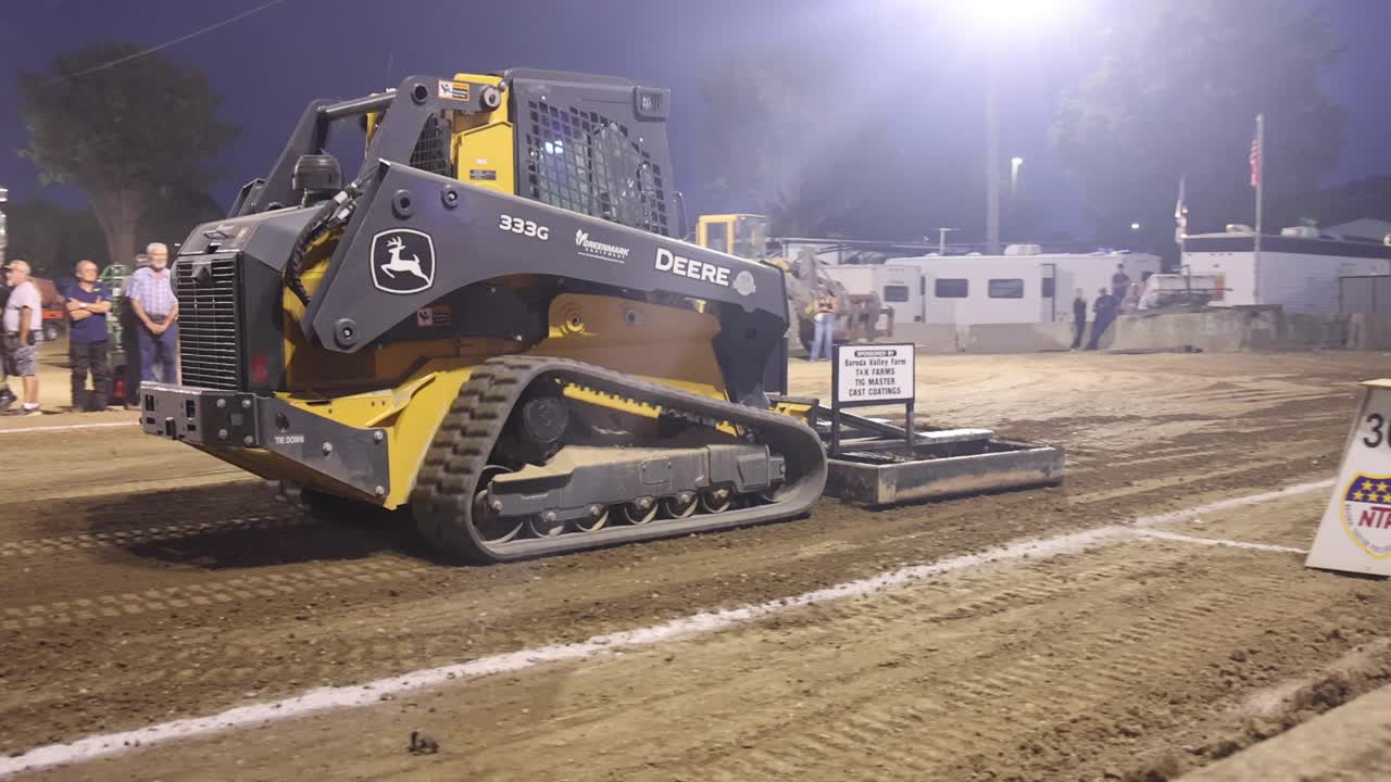 Skid steer grading track at tractor pull event