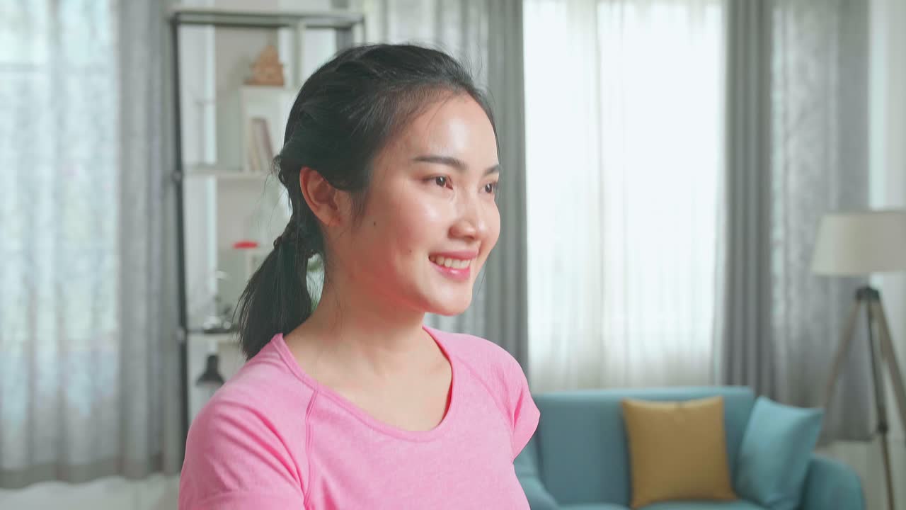 Side View Of Asian Woman Training On Walking Treadmill At Home