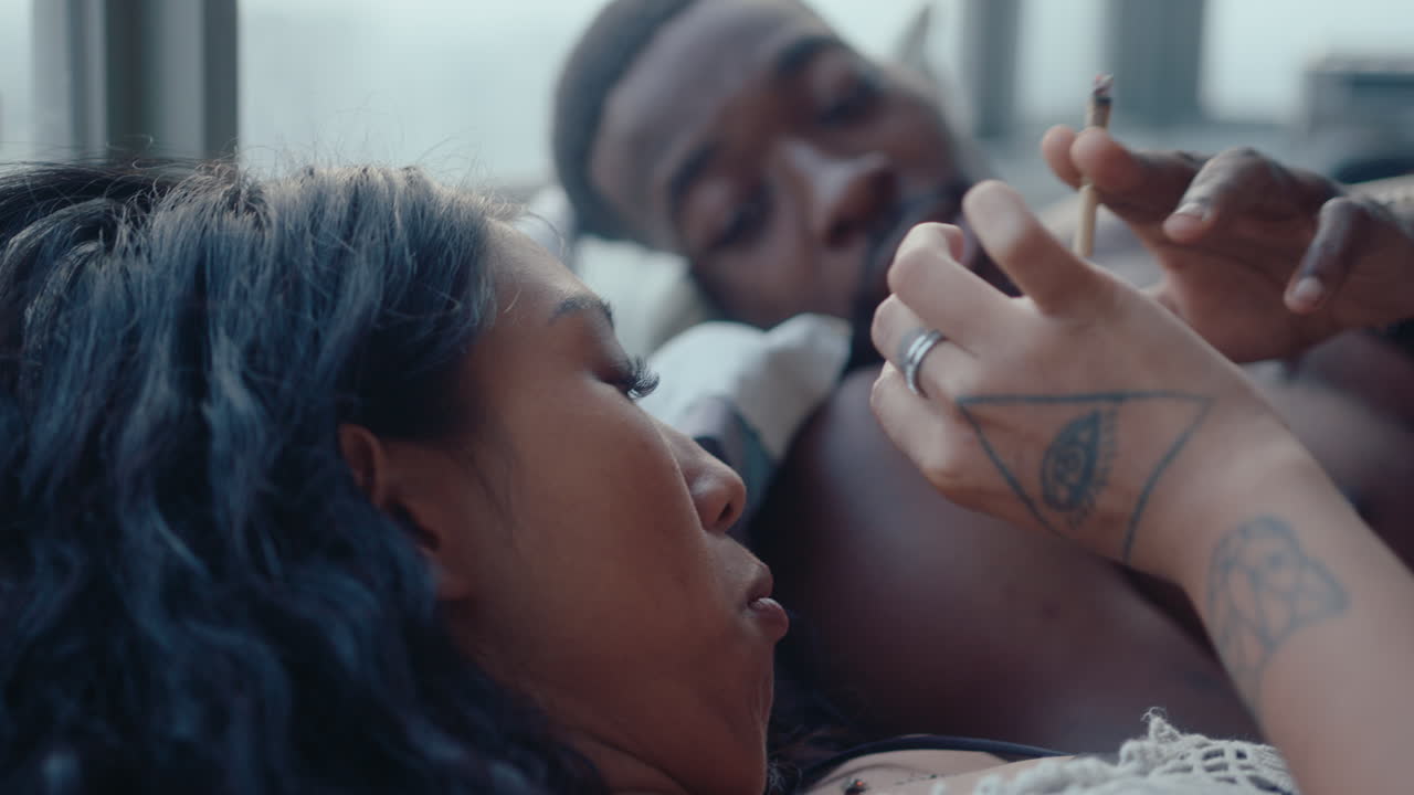 Romantic Couple Smoking a Cigarette on Bed