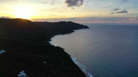 drone footage reveals a tranquil morning scene over st. croix’s coastline, with a colorful sky illuminating a quiet peninsula and the calm sea beneath in serene tropical light