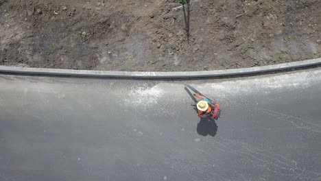 worker, cleaning the streets with a breeze of air. preparation for asphalting.