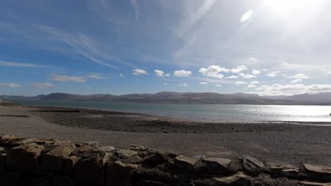 Bright-relaxing-sunny-Wales-UK-mountain-pebble-coastline-skyline-timelapse