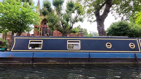 narrowboat travels along camden canal in london