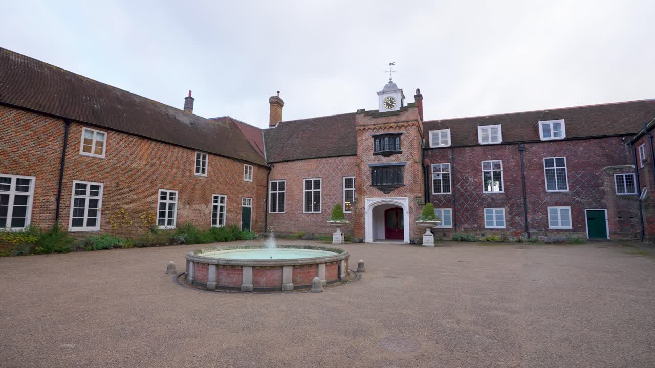 Immerse in a serene courtyard at Fulham Palace, where brick arches and lush gardens offer a peaceful glimpse into London’s storied past.