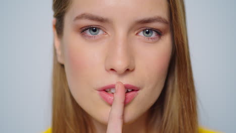 una mujer sensual y hermosa coqueteando ante la cámara en el estudio. una chica guardando un secreto.