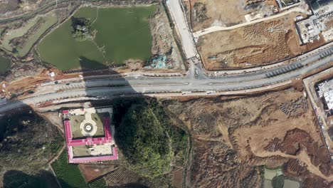 Aerial:-Chinese-city-construction-site-in-remote-countryside,-top-down-view