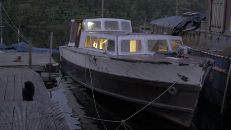 Wide-establishing-shot-of-double-diagonal-mahogany-timber-wooden-boat-at-Dusk