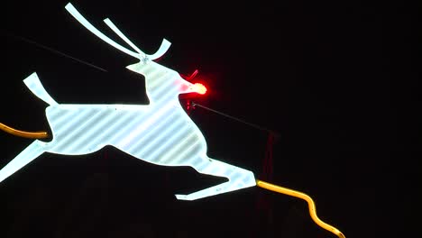 lite up rudolph neon sign in portland oregon at night