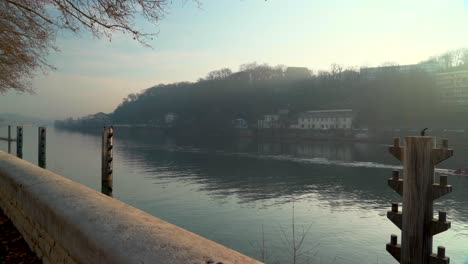 Wide-shot-of-rowers-passing-by-Great-Cormorant-in-Lyon,-France