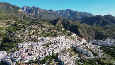 Frigiliana-white-mountain-village-in-Malaga,-Andalusia,-Spain---Aerial-4k-Backwards