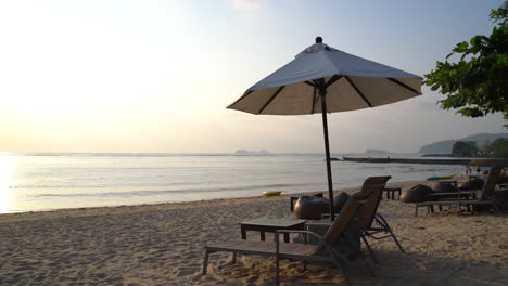 sunset with umbrella deck chair pool