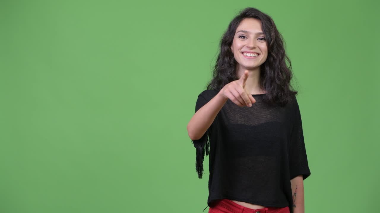 Young beautiful woman pointing at camera