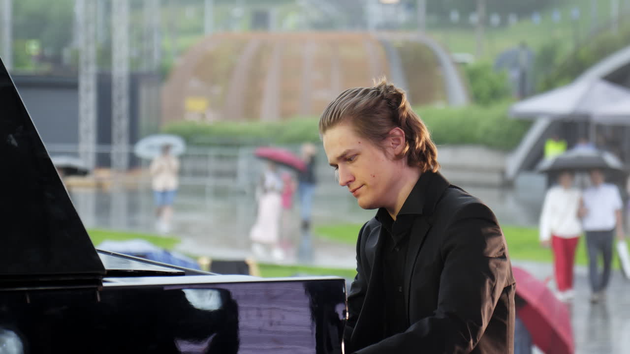 비가 내리는 야외에서 연주하는 피아니스트