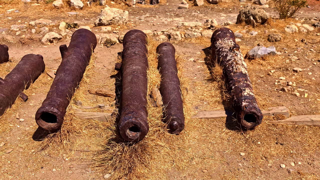 Vintage, rusted, old, iron cannons laying on the ground at a medieval fortress in Europe