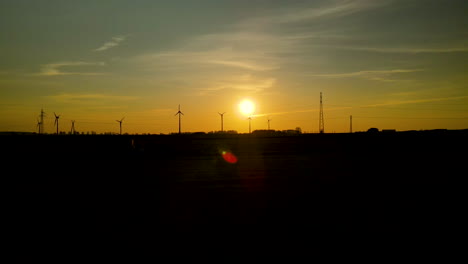 drone flying towards wind turbines