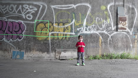 the camera dollies away from a young boy in an abandoned warehouse in slow motion