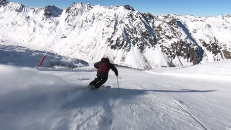 professional skier racing down a steep ski slope in rythmic short turns