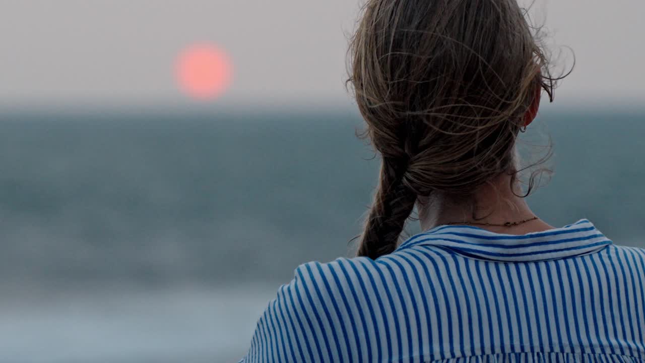 A serene moment in Galle, Sri Lanka, as a woman gazes at the vast ocean during a breathtaking sunset.