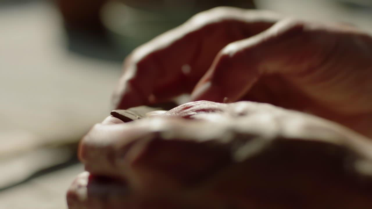 Close-up of Artisan Hands Shaping Clay Material