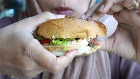 woman eating a delicious burger