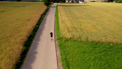 professional runner in rural place with farm fields of wheat