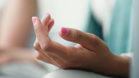 camera reveals a closeup of a hand that is in a meditating state