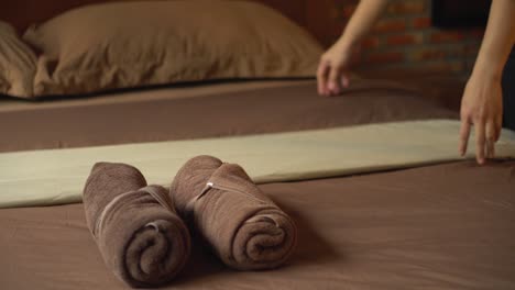 asia young maid chambermaid making bed in hotel room.