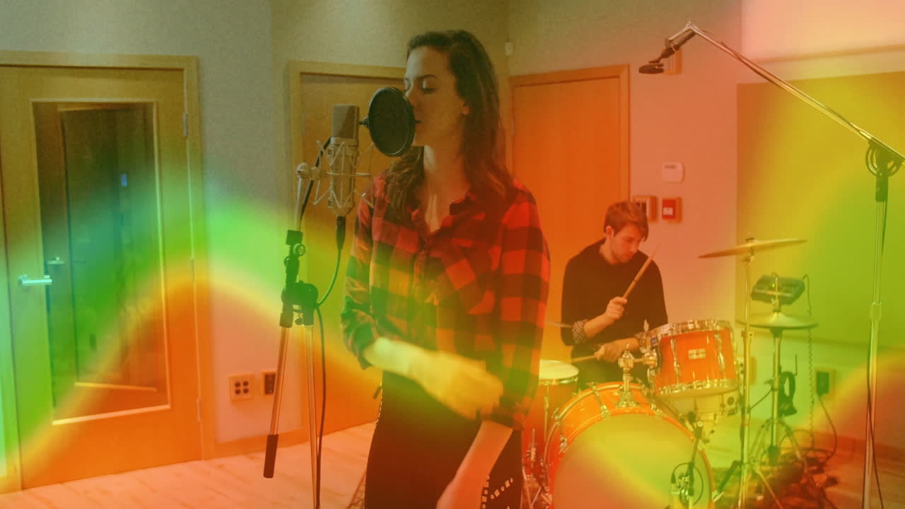 Bandmates performing in music production studio, showing animated sound waves and drum beat icons