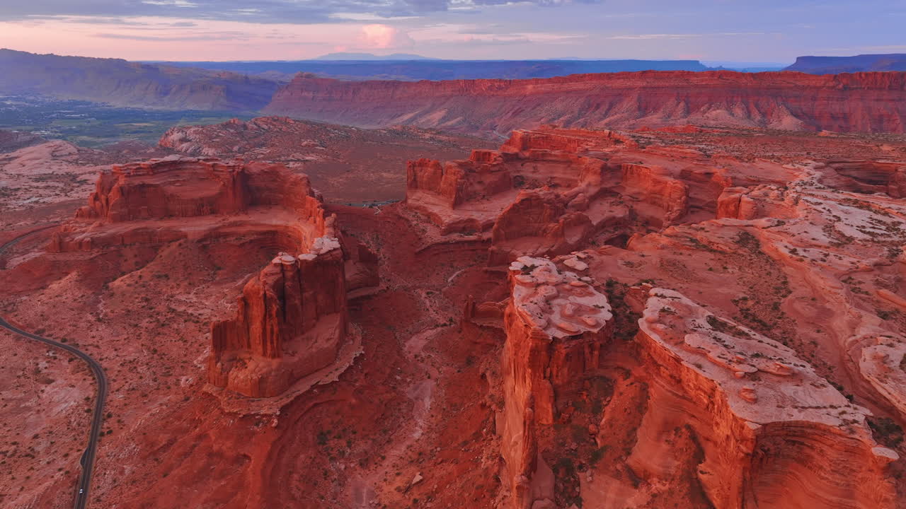 Footage above the stunning red canyons at the Arches National Park, Utah, USA. Drone flight over the scenery at sunset