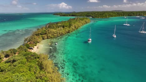 vava'u, tonga - a scenic view of a tropical island with boats moored on clear, turquoise waters - aerial pullback shot