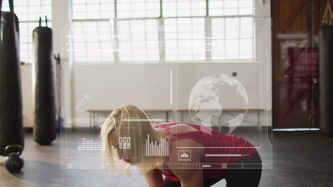 Woman lowering hips and driving kettlebell in gym, building strength while HUD charts tracking reps