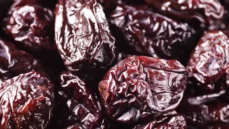 close up view of hands picking dried plums