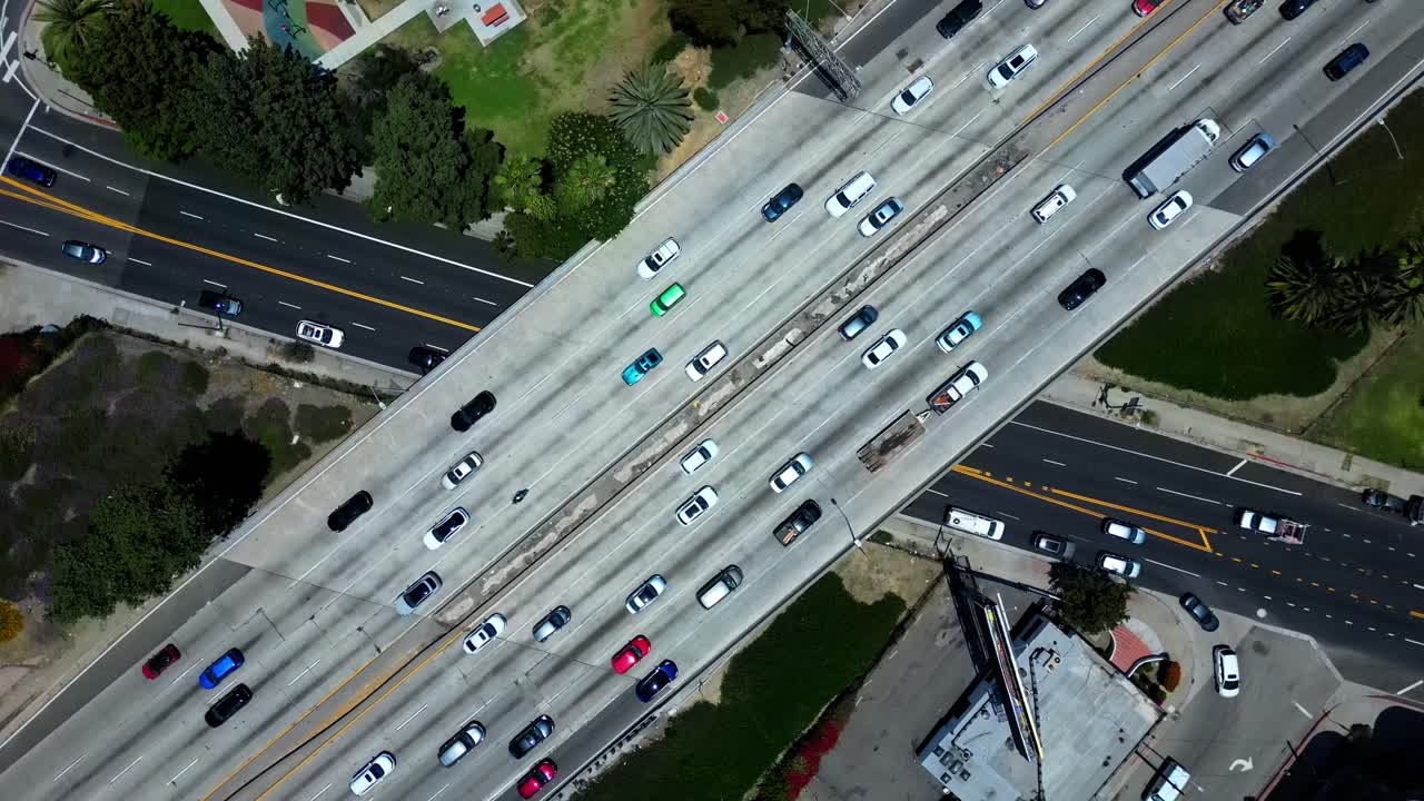 Aerial drone flying over a Los Angeles freeway with cars driving by in 4K 60FPS. Great for cityscape, urban, traffic, transportation, and travel projects